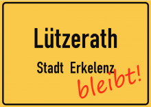 Luetzerath Ortsschild, mit "bleibt" in Rot.