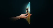 Eine Hand, die mit einer Figur aus dem Videospiel "world of warcraft" auf der Hand. Die Hand reicht durch eine Projektion eines Computerscreens.