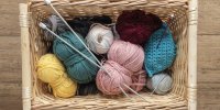Wolle und Stricknadeln im Korb